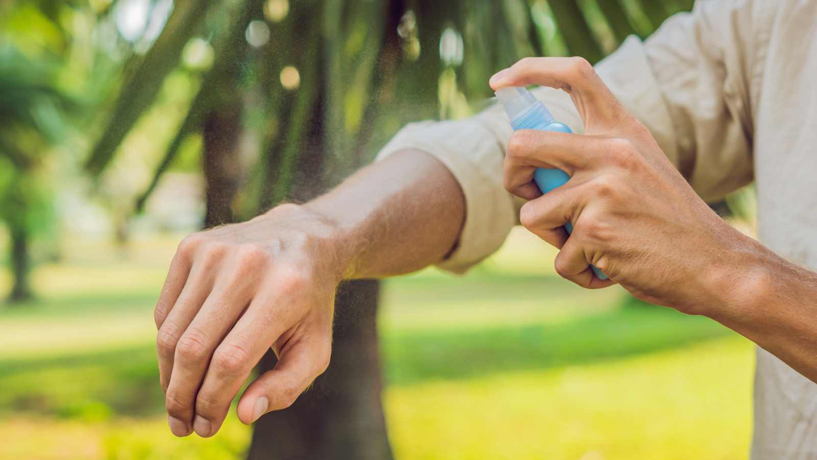 Man Spraying Arm with Homemade Insect Repellent